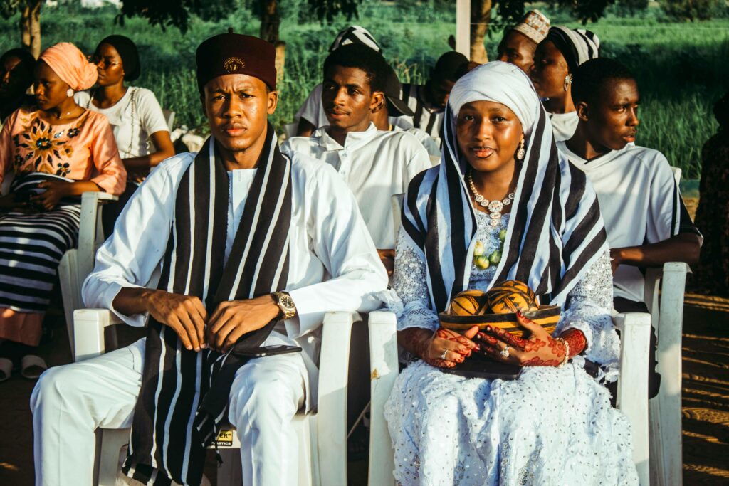 pexels photo 34011255 34011255 A vibrant traditional African wedding ceremony with attendees in cultural attire seated outdoors during the day.